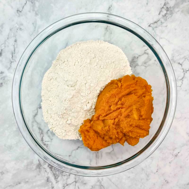 Overhead view of process shot 1 - in a large bowl, mix together the spice cake mix and pumpkin.