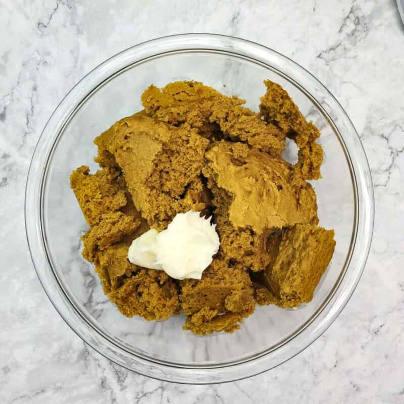 Overhead view of process shot 3 - once the cake is cool, break it into pieces and crumble it into a large bowl. Add the cream cheese frosting and mix until you have a dough.