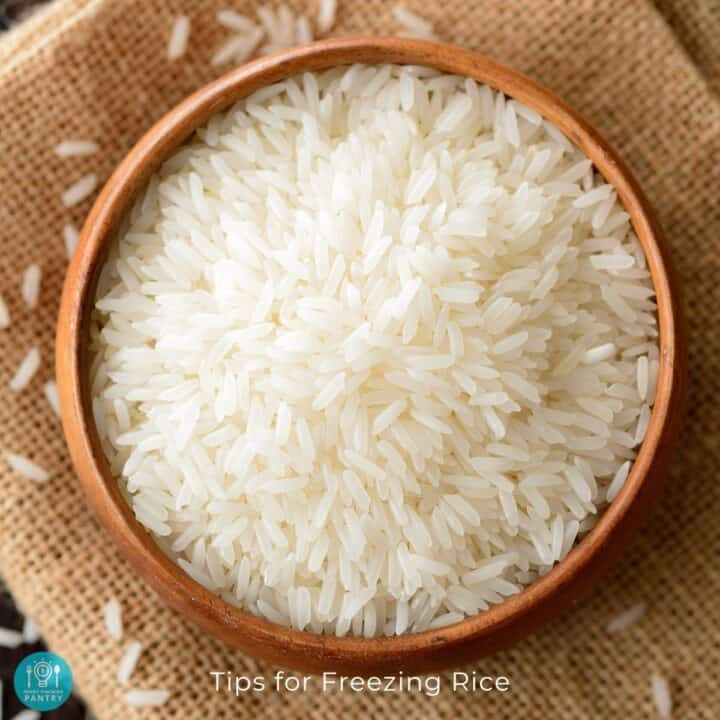 Bowl of uncooked rice resting on a piece of burlap, viewed from overhead.