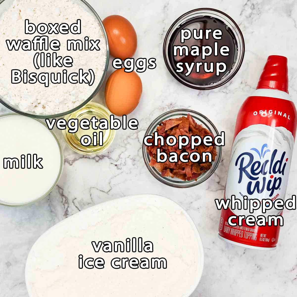 Overhead shot of ingredients - boxed waffle mix, eggs, vegetable oil, milk, pure maple syrup, chopped bacon, vanilla ice cream, and whipped cream.