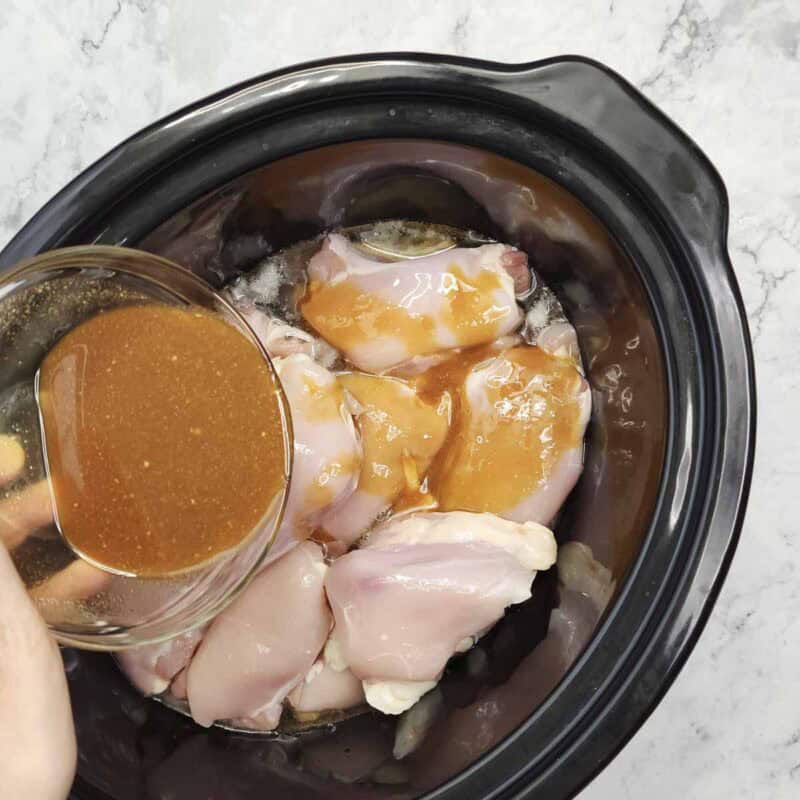 Overhead view of process shot 5 - pour the soy sauce mixture over the chicken.