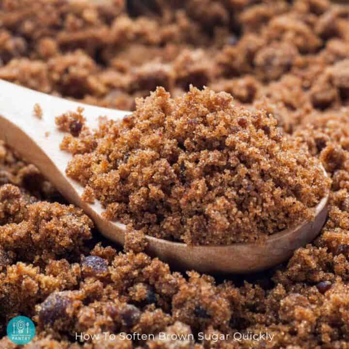 A spoonful of brown sugar nestled on a pile of more brown sugar.