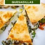 Overhead close up shot of multiple slices of spinach mushroom quesadillas on a white plate.
