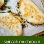 Overhead view of whole spinach mushroom quesadillas on a baking sheet lined with parchment paper.