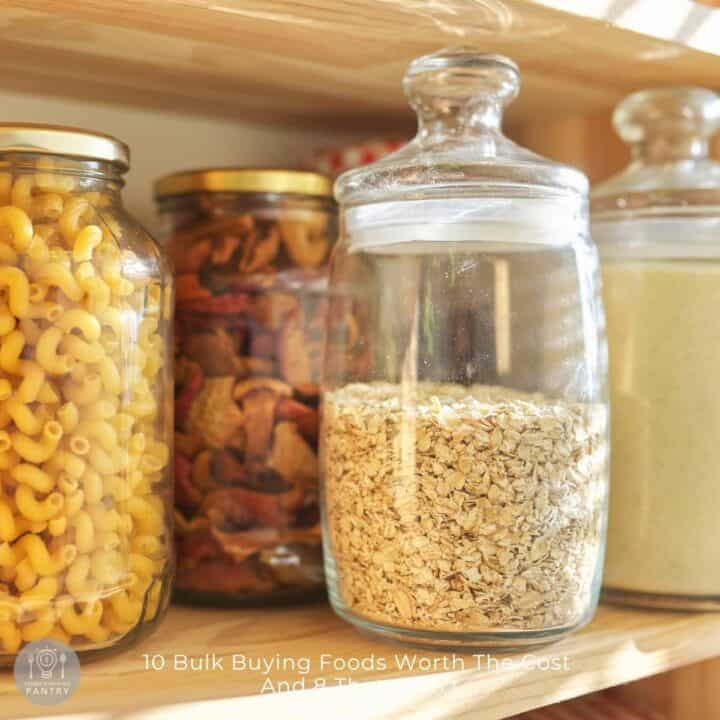 Glass jars with dry food ingredients such as oats and flour on wooden shelf to illustrate bulk buying foods worth the money.