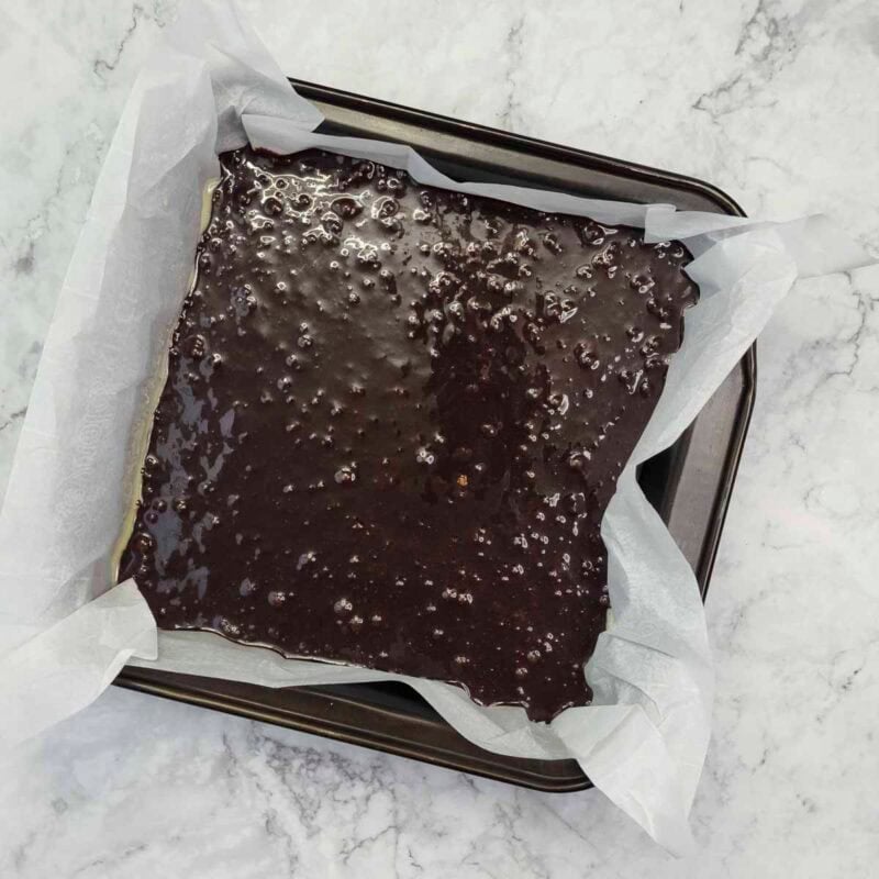 Overhead view of process shot 6 - pour the batter into the prepared pan and tap it a few times on the counter to remove air bubbles.