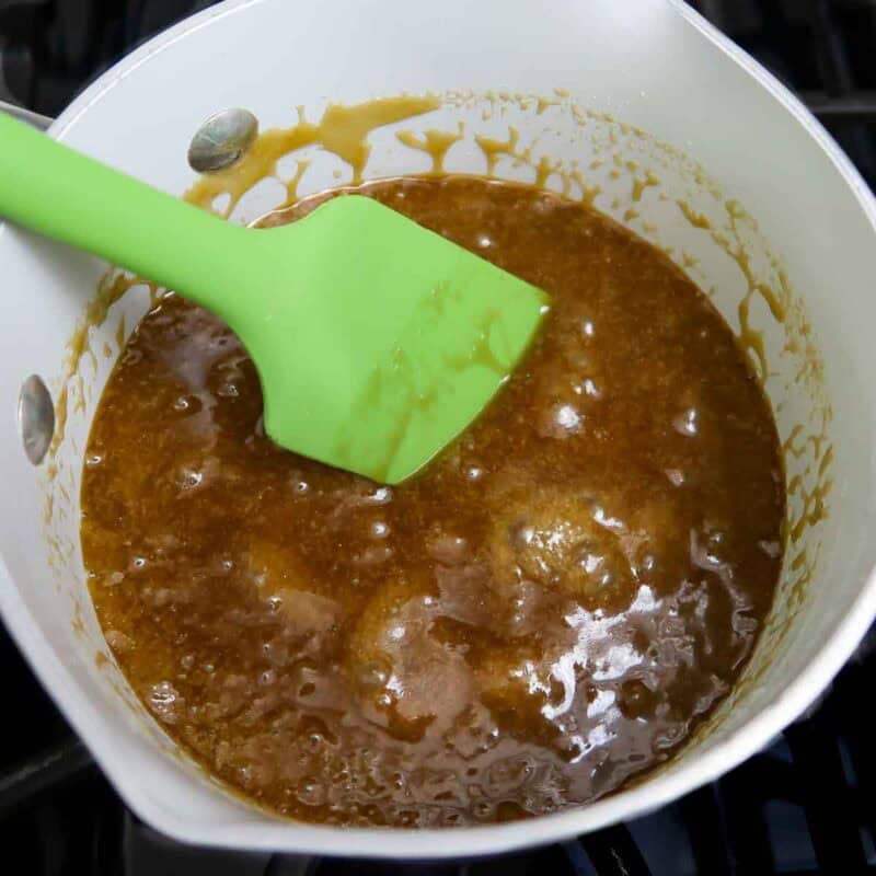 Overhead view of process shot 2 - in a small saucepan, melt the butter and combine with the brown sugar. Bring to a boil and stir for about 5 minutes while boiling on low heat.