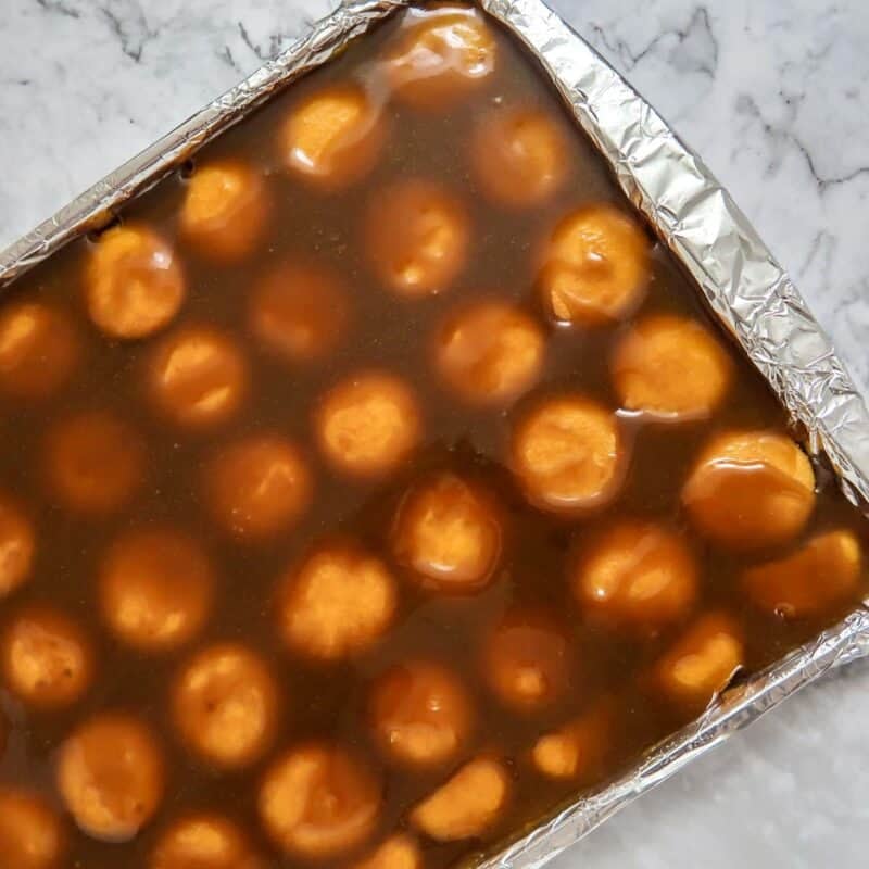 Overhead view of process shot 3 - pour the butter and brown sugar mixture evenly over the vanilla wafers.