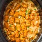 Overhead shot of cowboy casserole in the slow cooker garnished with frehs herbs.