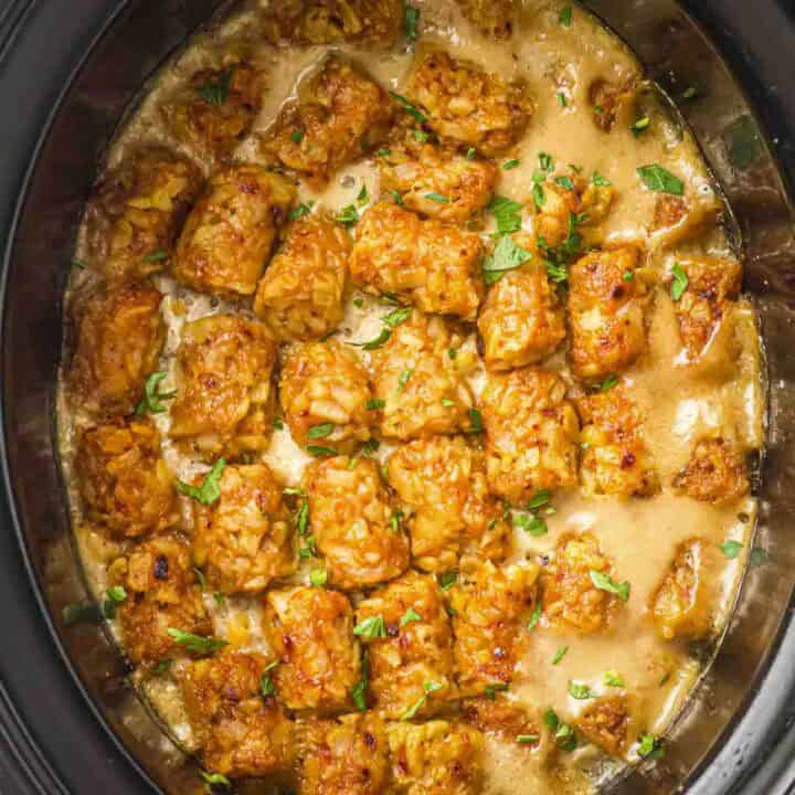Overhead shot of cowboy casserole in the slow cooker garnished with frehs herbs.