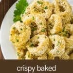 Overhead view of baked calamari with herbs on a white plate.