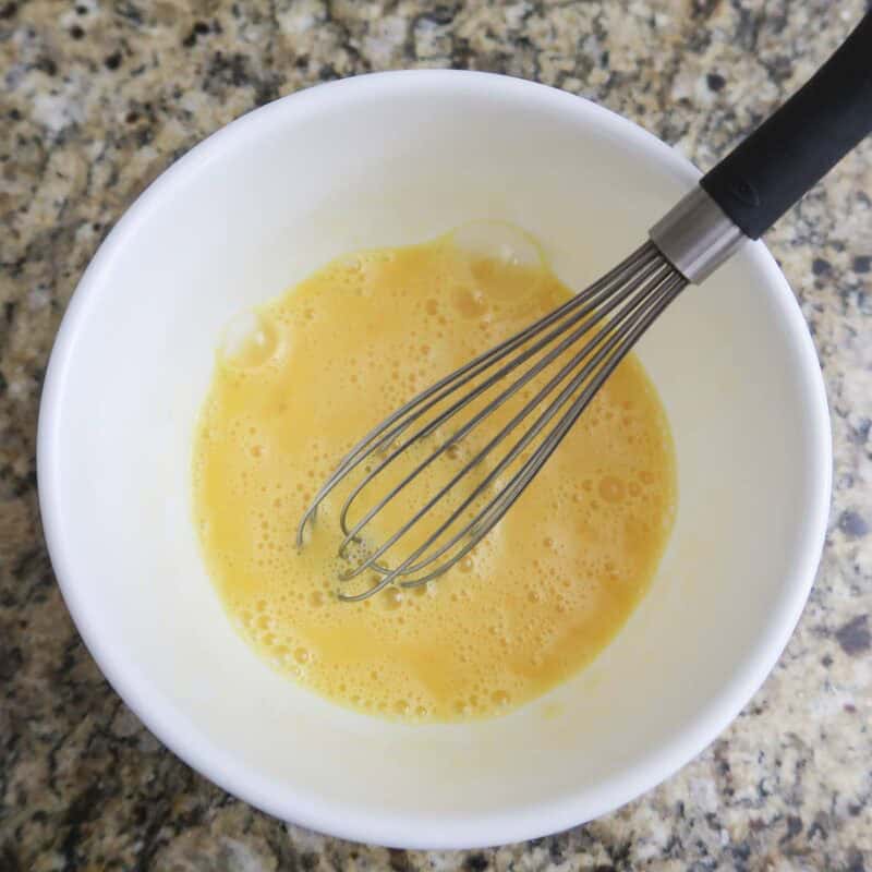 Overhead view of process shot 2 - in a separate bowl, beat eggs thoroughly.