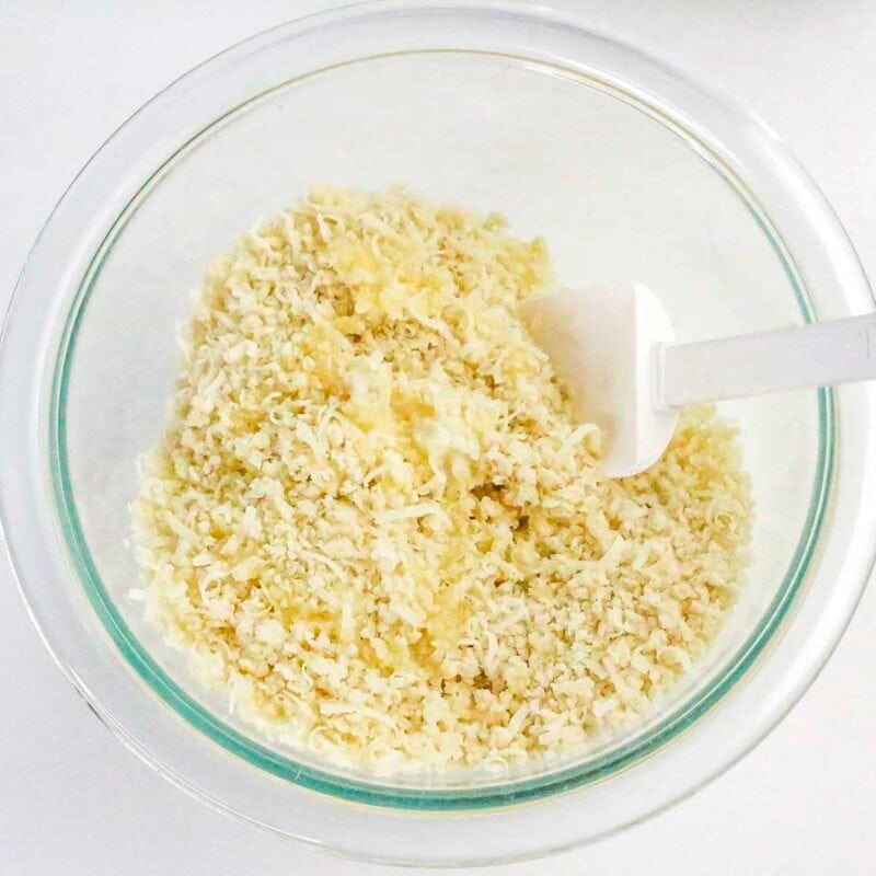 Overhead view of process shot 5 - in a small bowl, mix the parmesan, breadcrumbs, and melted butter.