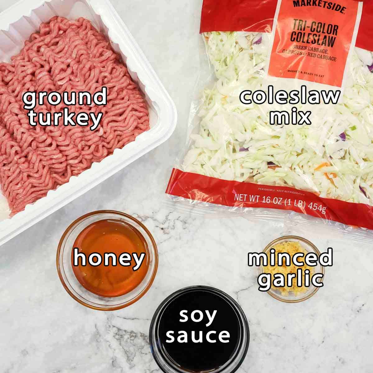 Overhead view of ingredients - ground turkey, coleslaw mix, honey, soy sauce, and minced garlic.