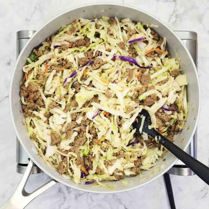 Overhead view of process shot 5 - cook for 2-3 minutes more so that the cabbage softens but still has some crunch.