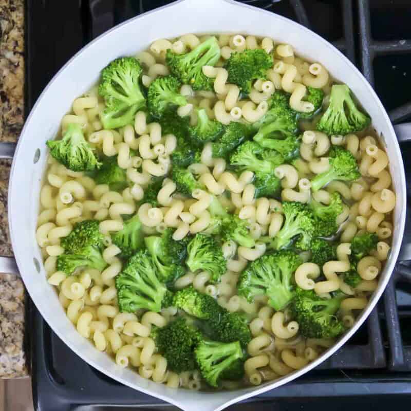 Overhead view of process shot 1 - cook the pasta according to the instructions on the package. During the last two minutes of cooking, add the broccoli.