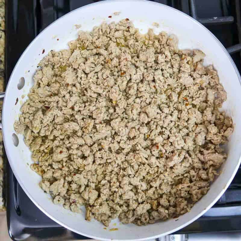 Overhead view of process shot 3 - break the turkey into pieces, while cooking until browned.