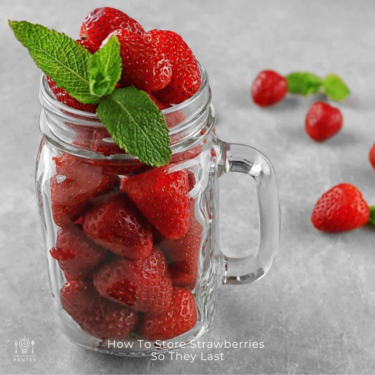 Glass jar filled with whole, fresh strawberries to illustrate that the article is about how to store strawberries.