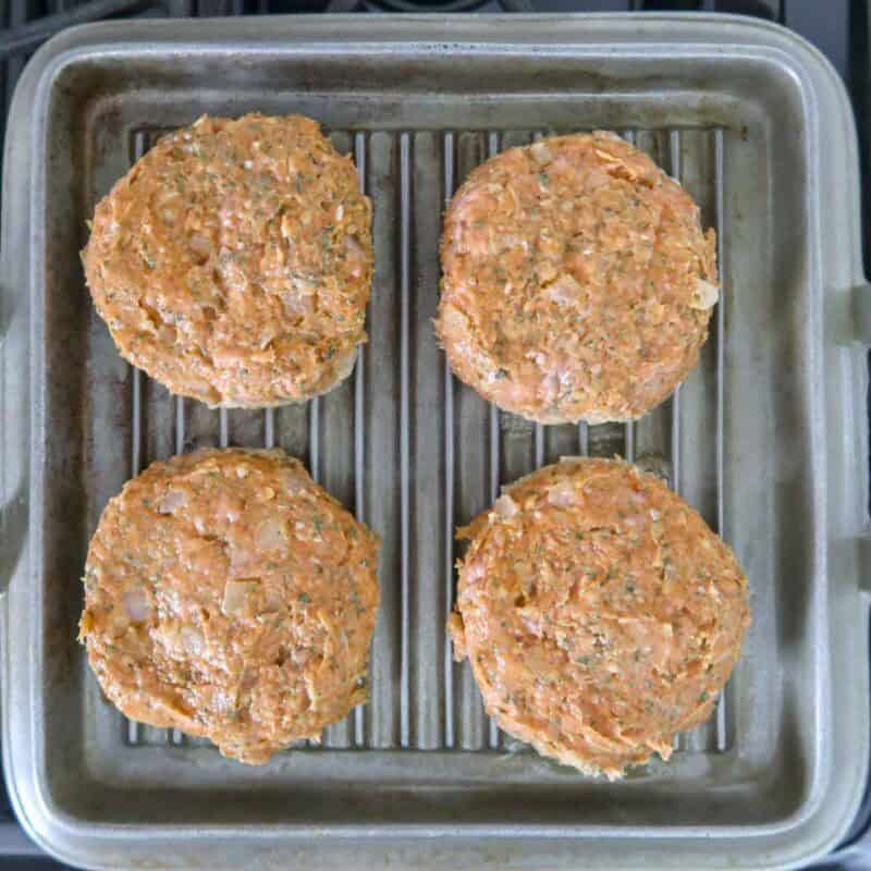 Overhead view of burger process shot 4 - place the patties on the grill and cook for about 4 minutes on each side.