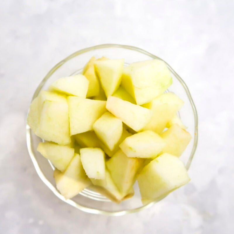 Overhead view of process shot 1 - chop the apple into small chunks.