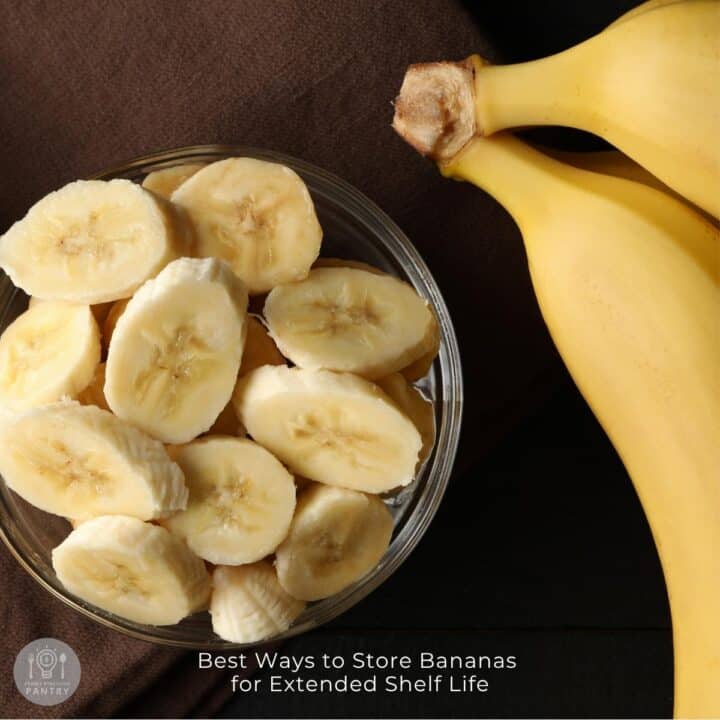 Overhead view of banana slices in a bowl and whole bananas.