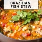 Side view of stew garnished with fresh parsley in brown pot on a brown placemat.