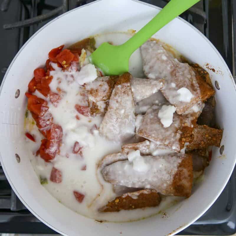 Overhead view of process shot 4 - pour the coconut milk over everything, mix and cover, and simmer about 20 minutes, stirring occasionally.