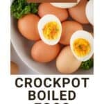 Side view of multiple boiled eggs with three eggs peeled and cut in half on top in a white bowl with fresh herbs on the sides.