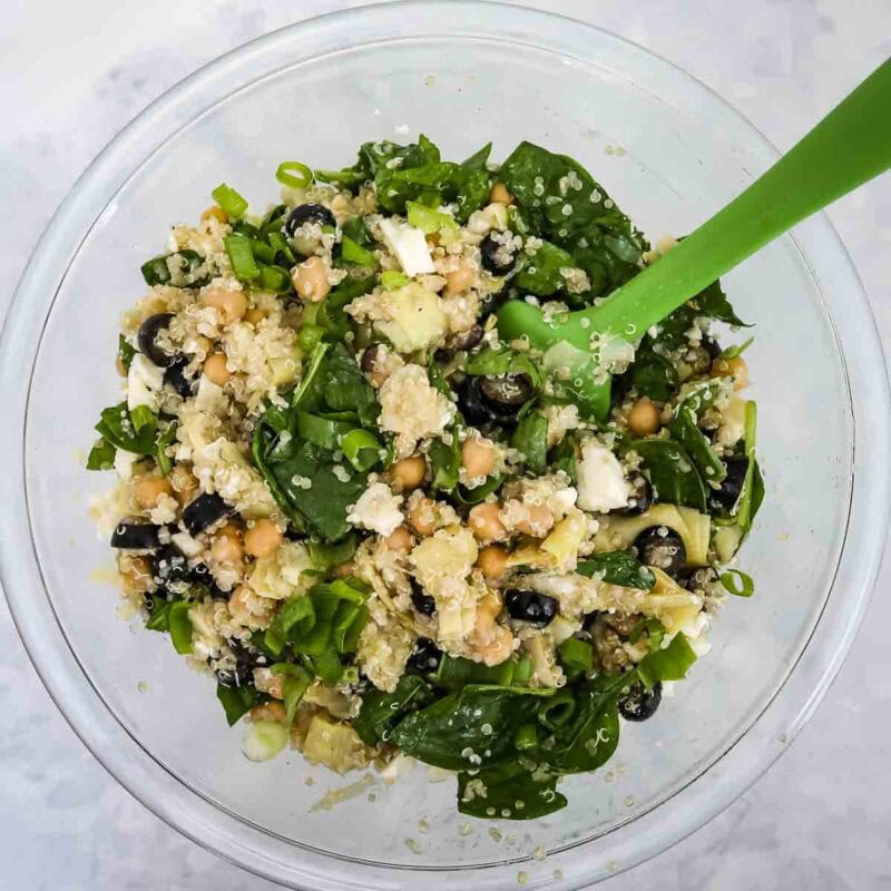Overhead view of process shot 4 - add the spinach, scallions, feta, and stir until the spinach is slightly wilted.