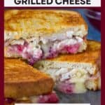Side shot of three halves of turkey brie grilled cheese stacked on a black speckled plate with sliced brie and cranberry sauce in the background.