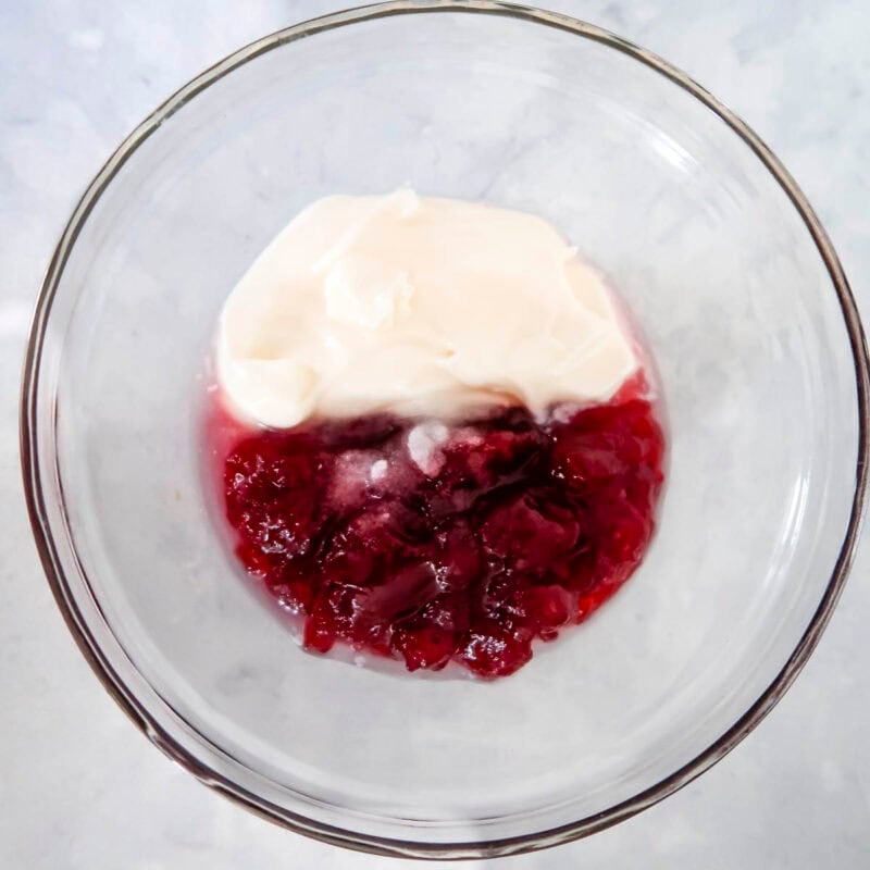 Overhead view of process shot 1 - combine the cranberry sauce, mayonnaise, lemon juice, and salt in a small bowl.