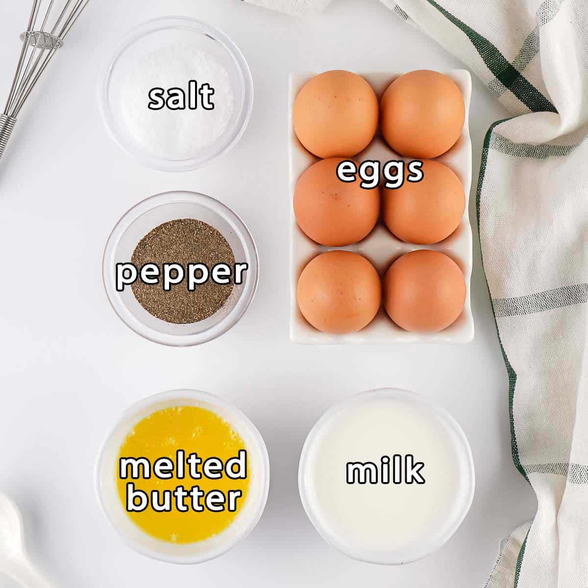 Overhead shot of ingredients - eggs, milk, melted butter, salt, and pepper.