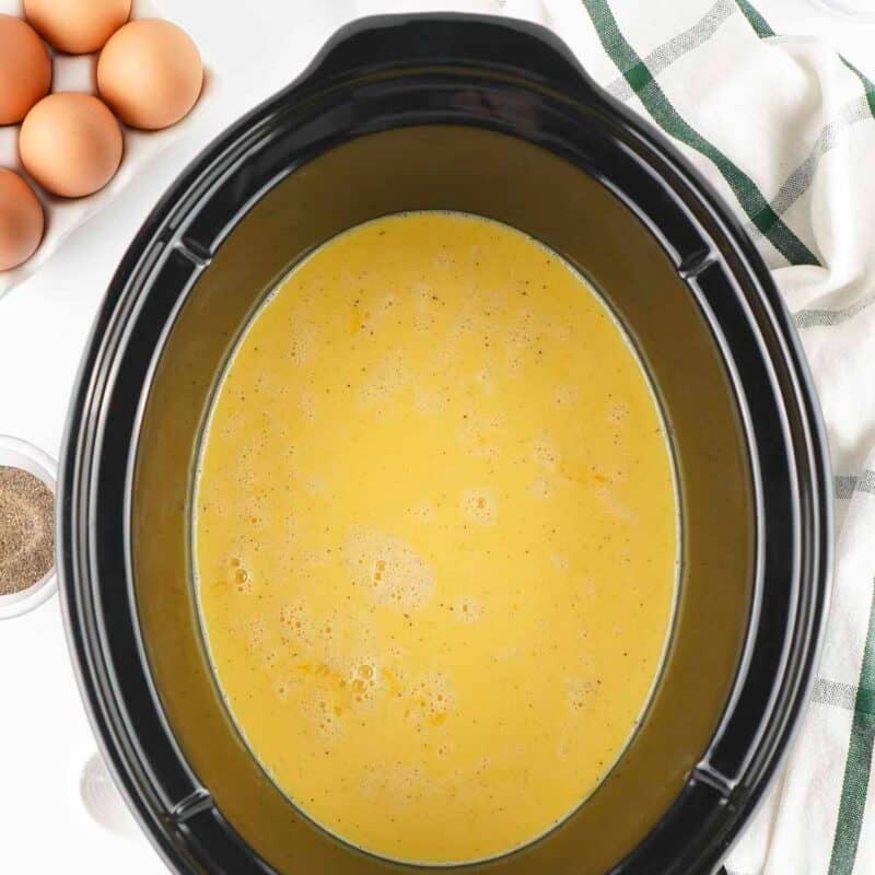 Overhead view of process shot 4 - pour the egg mixture into the crockpot. Cover and cook on high for 1.5 hours.