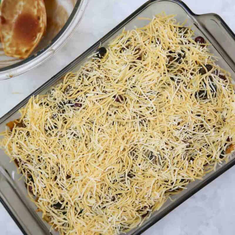 Overhead view of process shot 5 - add remaining doritos, then distribute the remaining sauce on top, then add the final layer of remaining cheese. Bake for 25-30 minutes.