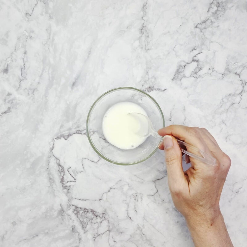 Overhead view of process shot 1 - in a small bowl, mix the cornstarch with about 1 ½ tablespoons water.