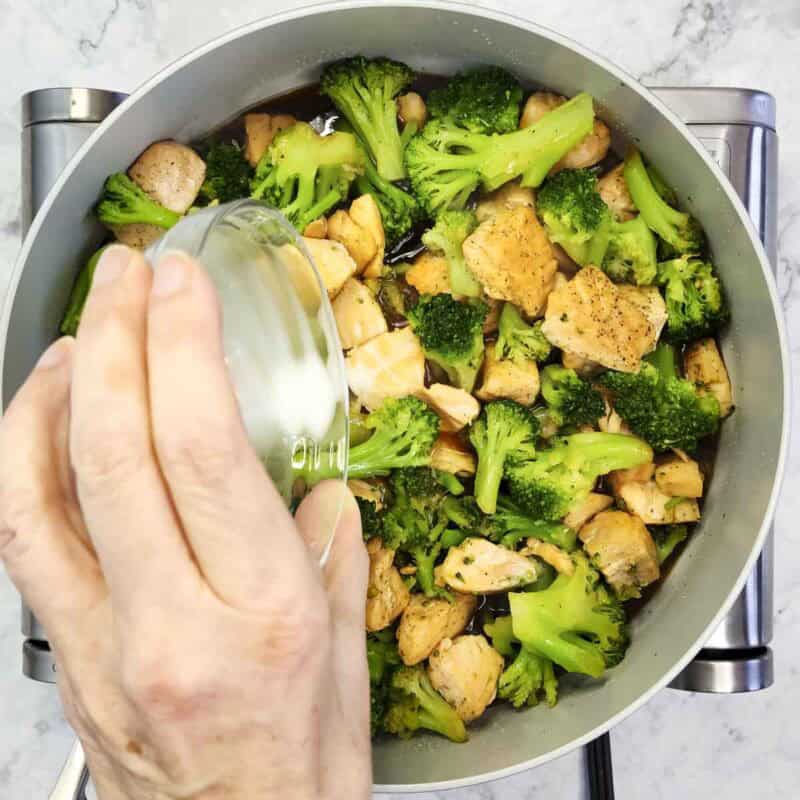 Overhead view of process shot 4 - add the broccoli and teriyaki sauce to the pan and cook for a couple of minutes, until the sauce is hot and bubbling. Add the cornstarch slurry into the pan.