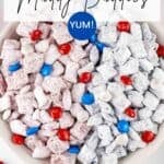 Overhead shot of patriotic muddy buddies in a white bowl on a white surface.