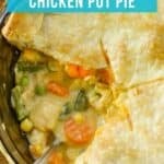 Overhead close up shot of chicken pot pie with a slice taken out in a casserole dish with a spoon on the side.
