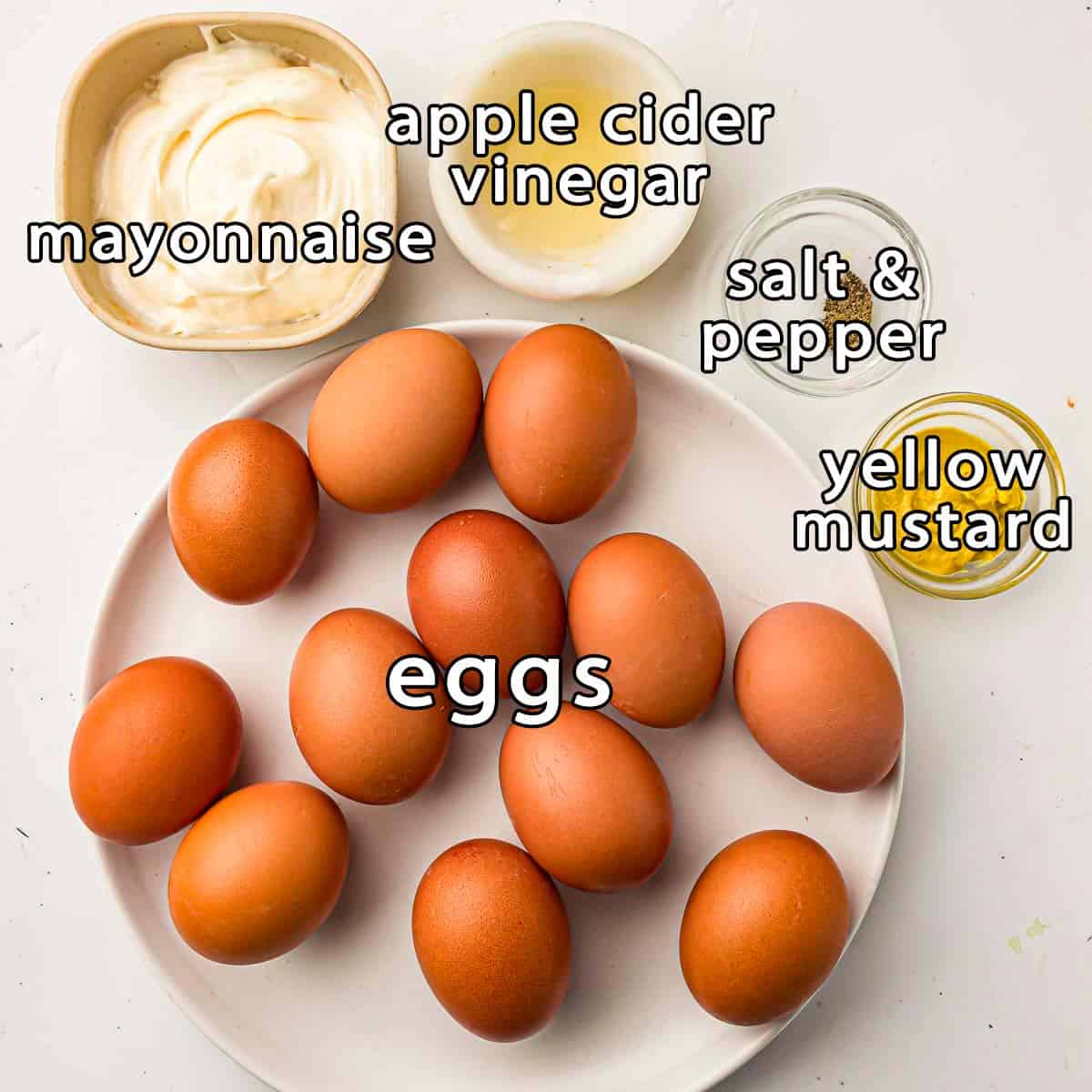 Overhead view of ingredients - eggs, mayonnaise, apple cider vinegar, yellow mustard, salt, and pepper.