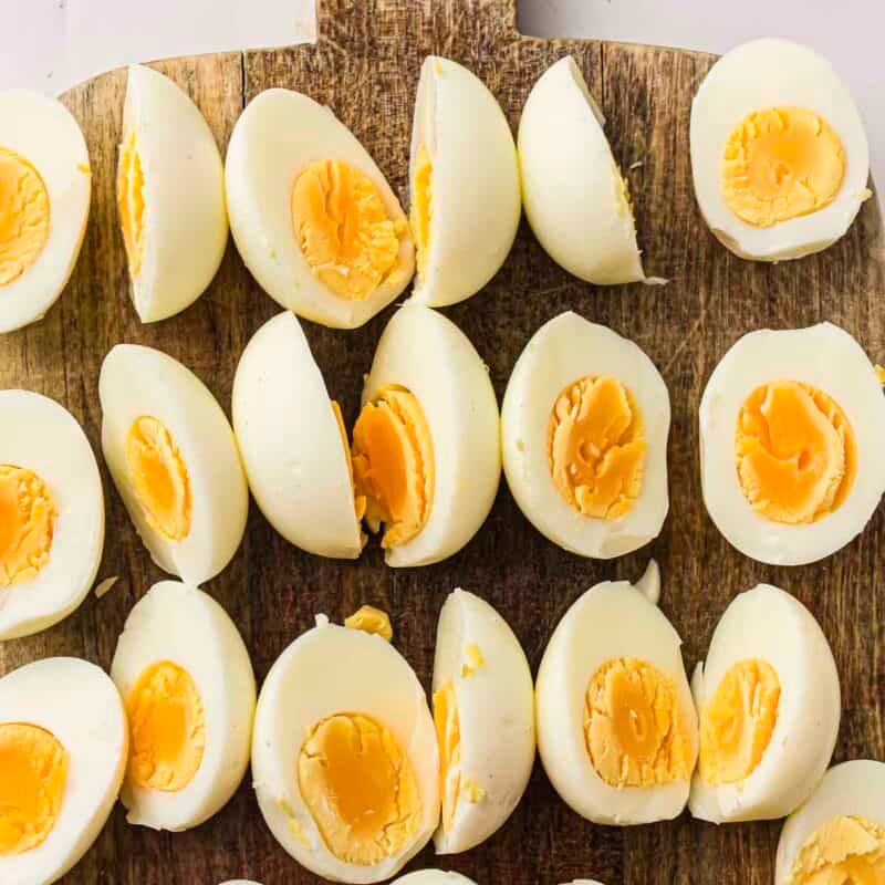 Overhead view of process shot 2 - peel the eggs and slice each one in half lengthwise.