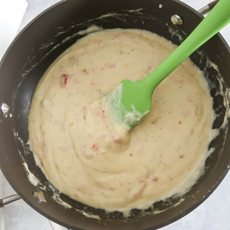 Overhead view of process shot 5 - heat and stir until the cheeses are melted and the mixture is hot and bubbly.