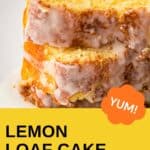 Side shot of two slices of lemon loaf cake stacked on a white plate.