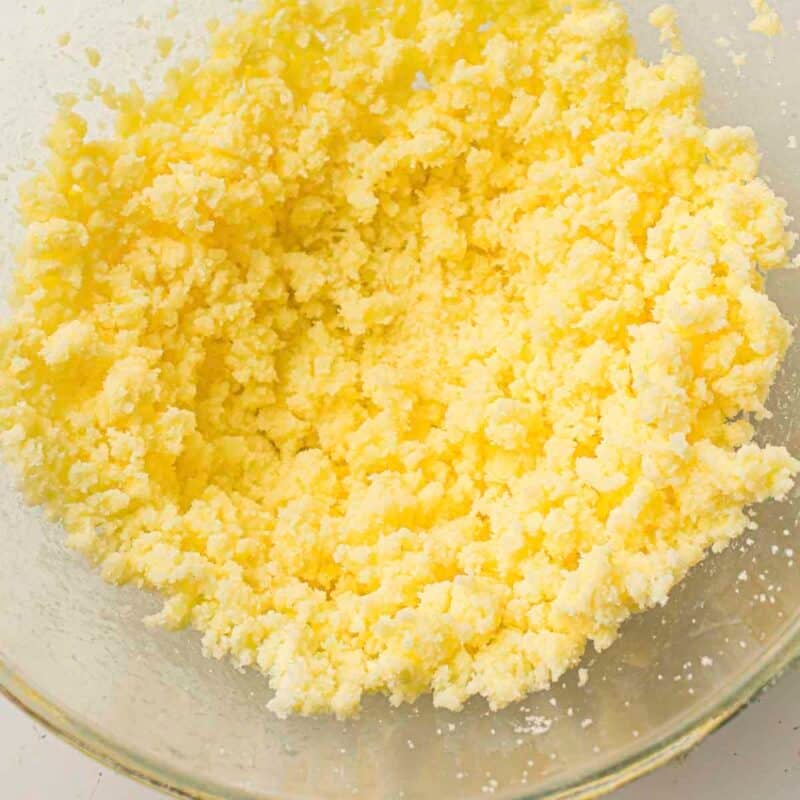 Overhead view of process shot 1 - in a large bowl, beat the butter and sugar together until light and fluffy.