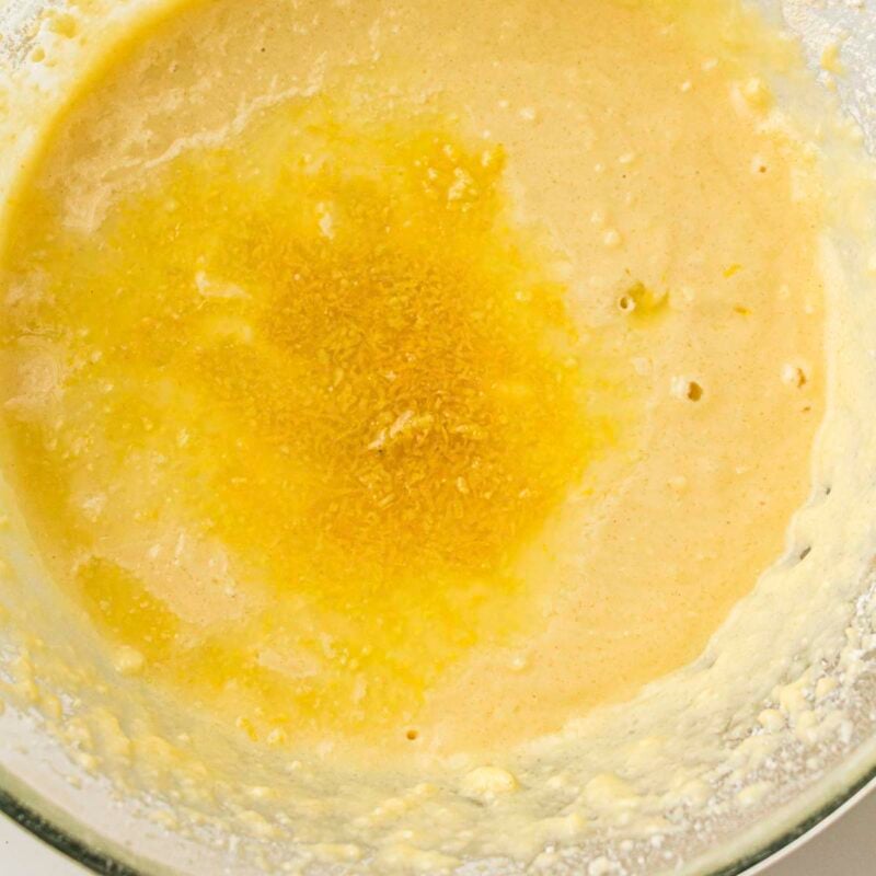 Overhead view of process shot 4 - stir in the lemon zest, lemon juice, and vanilla extract.