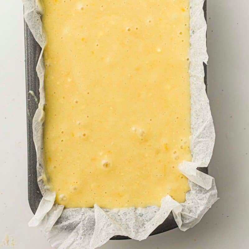 Overhead view of process shot 5 - pour the batter into the prepared pan and smooth the top. Bake for 50-60 minutes, until a toothpick inserted into the center comes out clean.
