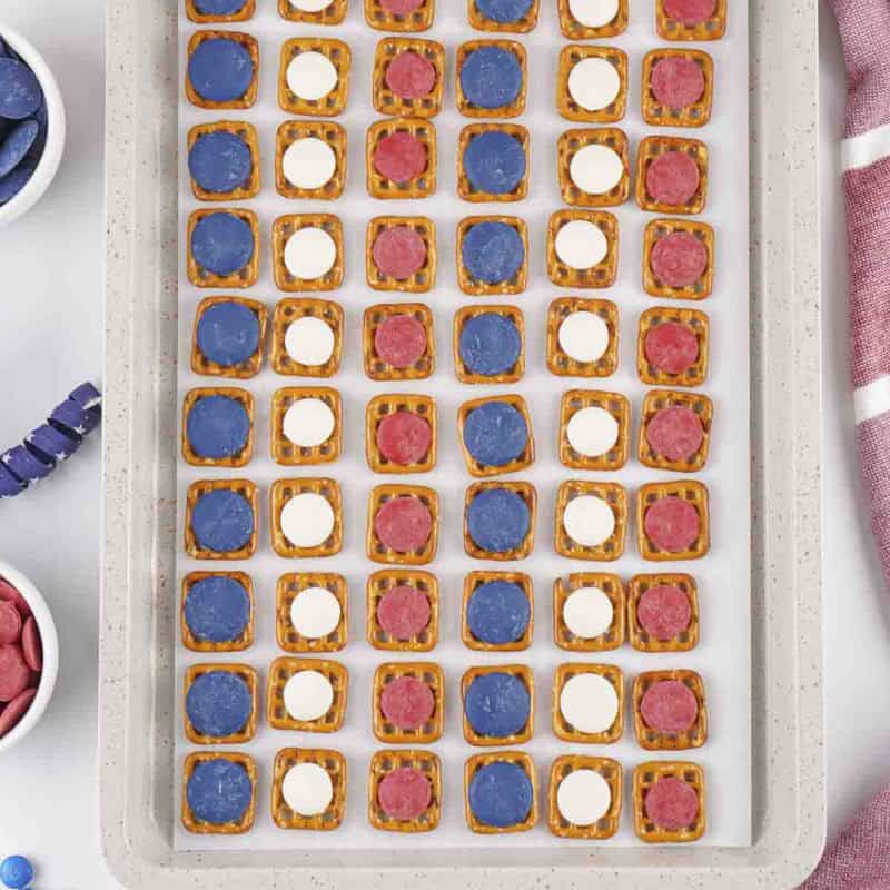 Overhead view of process shot 2 - put one candy melt on each pretzel until all the pretzels are full.