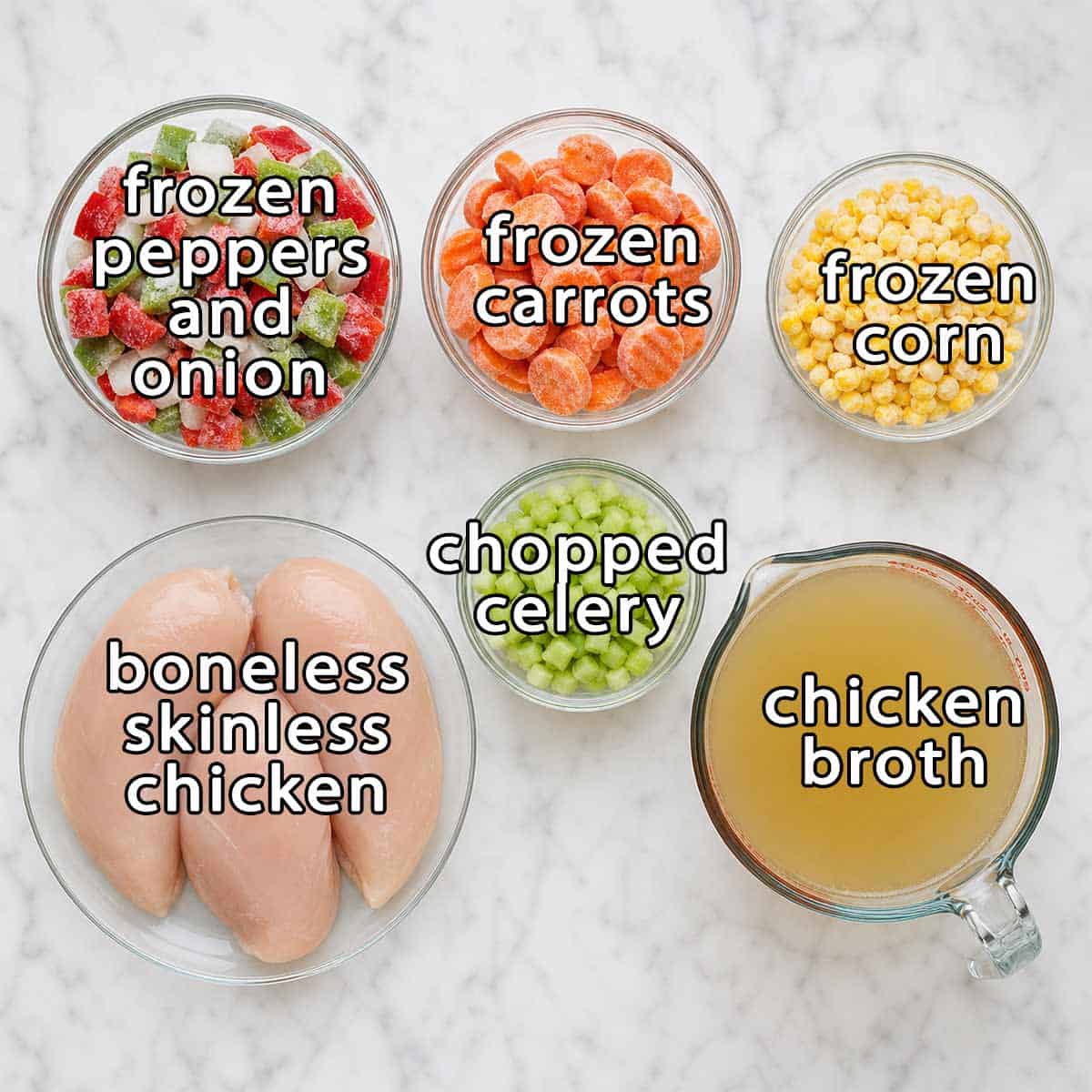 Overhead shot of ingredients - frozen peppers and onions, frozen carrots, frozen corn, chopped celery, boneless skinless chicken breasts, and chicken broth.