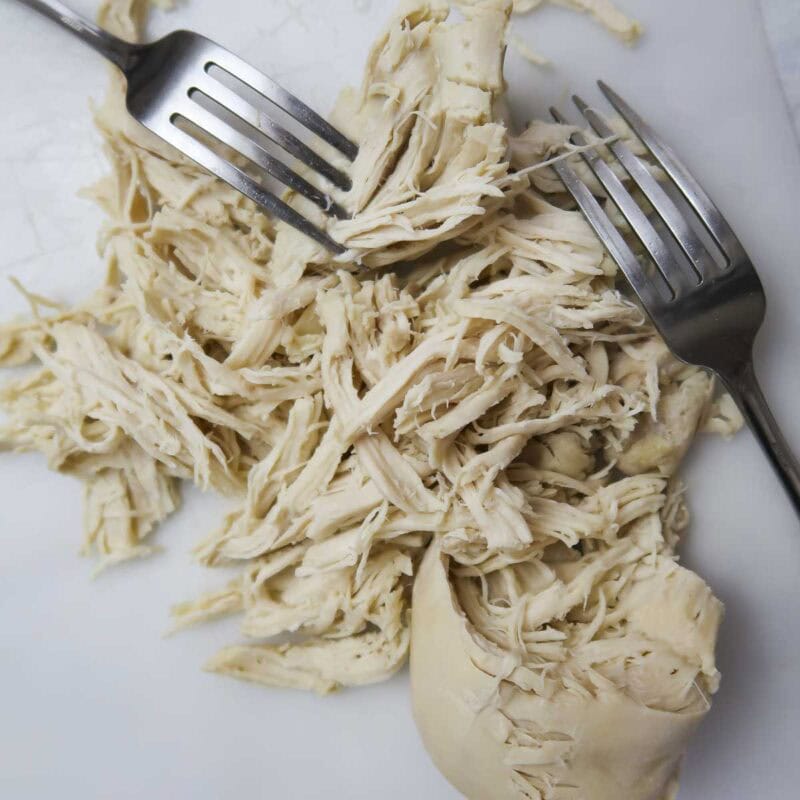 Overhead view of process shot 4 - right before serving, remove the chicken and shred it with two forks.