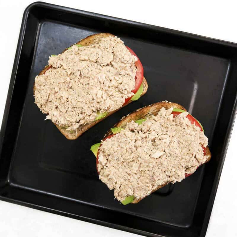 Overhead view of process shot 5 - distribute the tuna salad on top of the tomato.