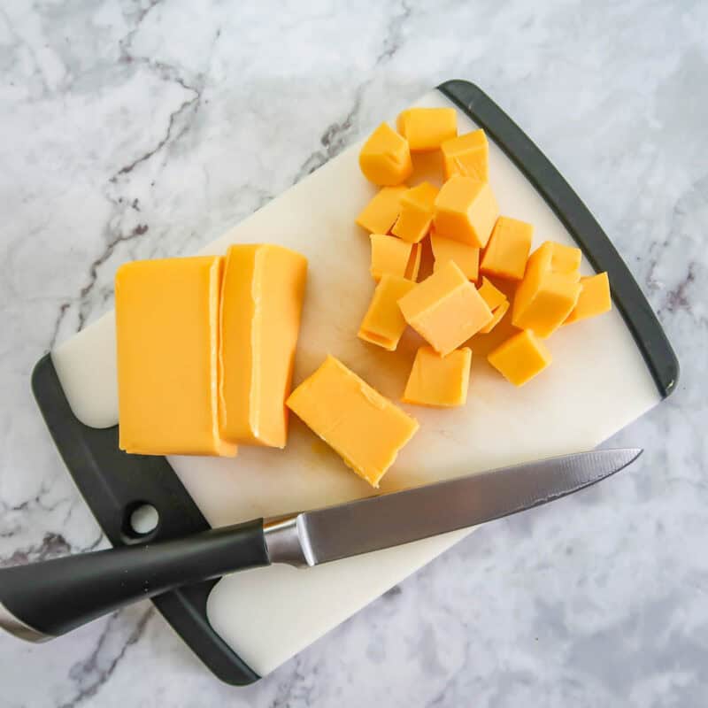 Overhead view of process shot 2 - slice the cheese into cubes.